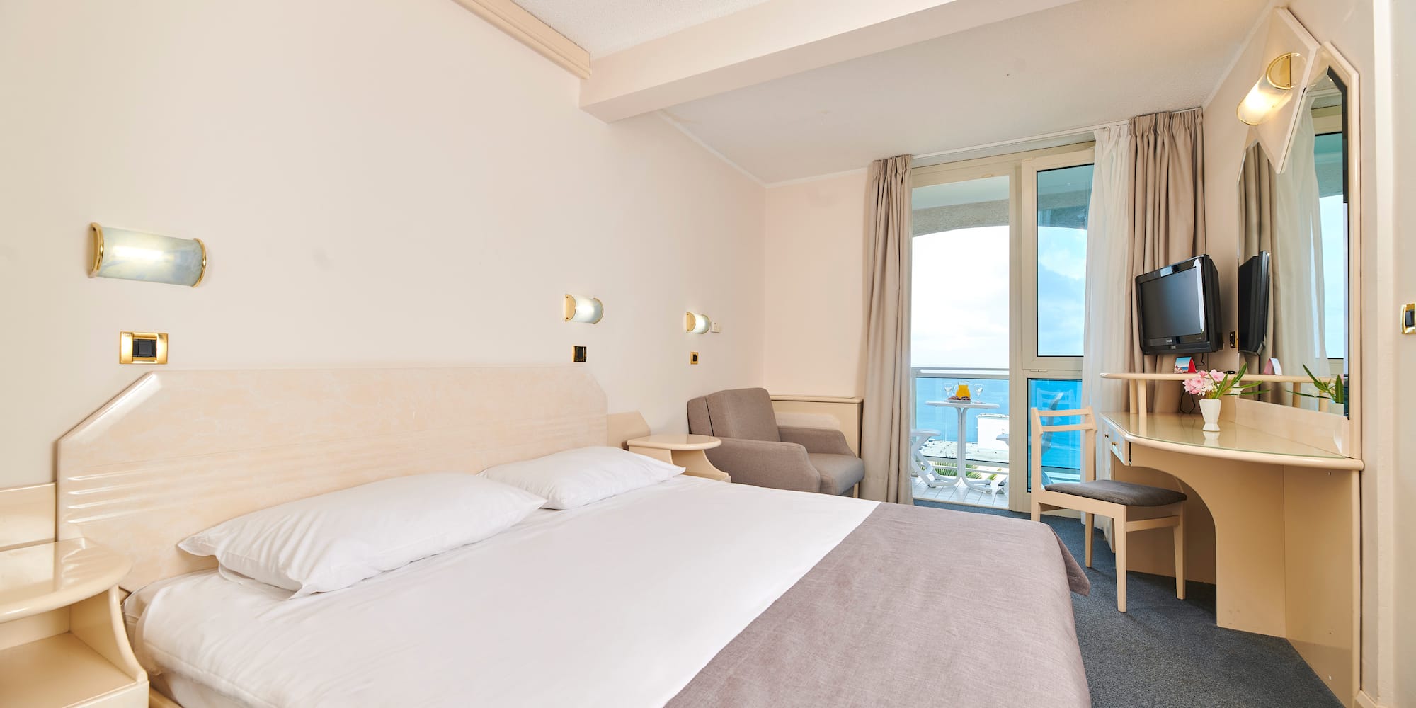 a room with a bed and a television