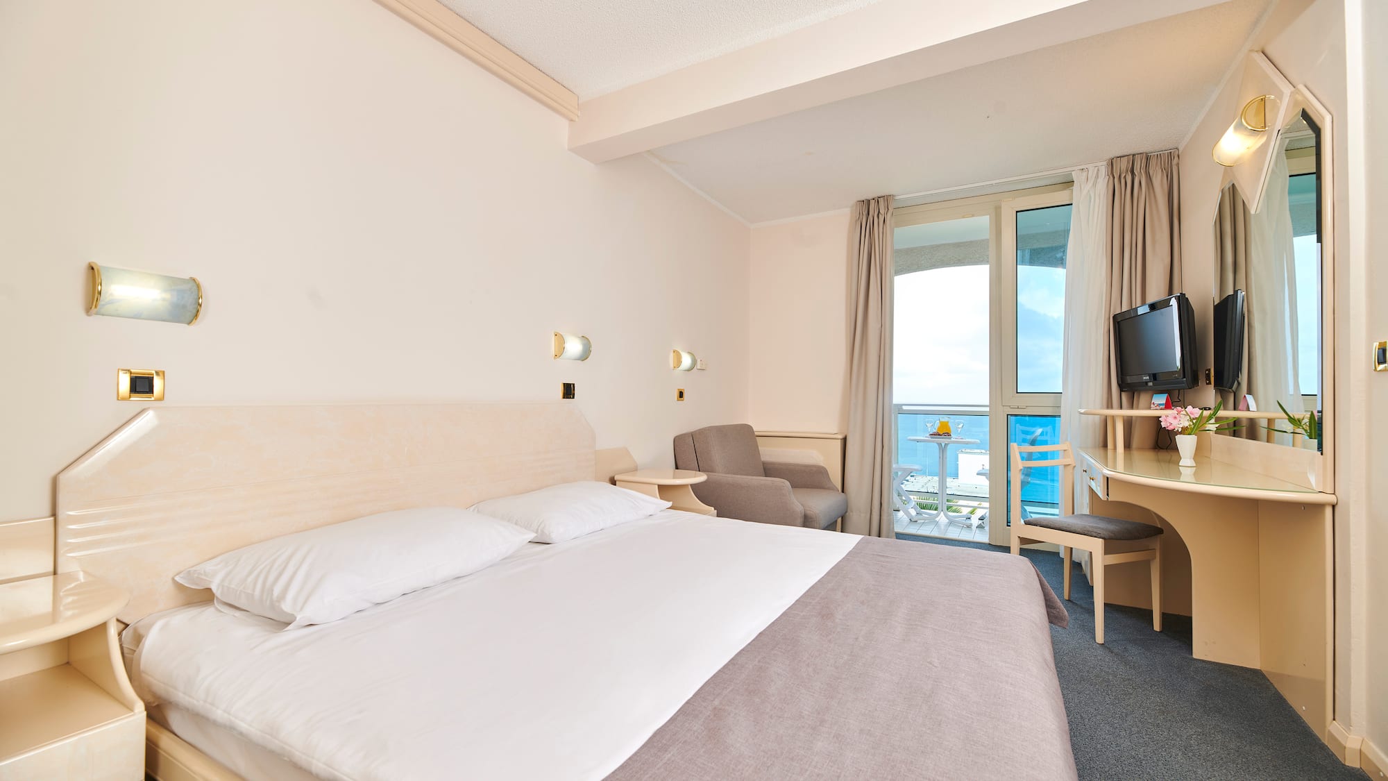 a room with a bed and a television