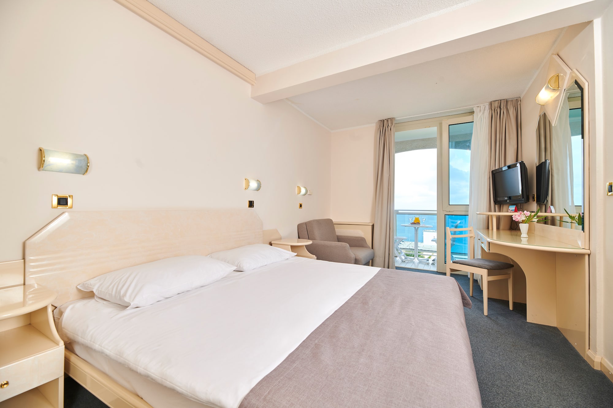 a room with a bed and a television