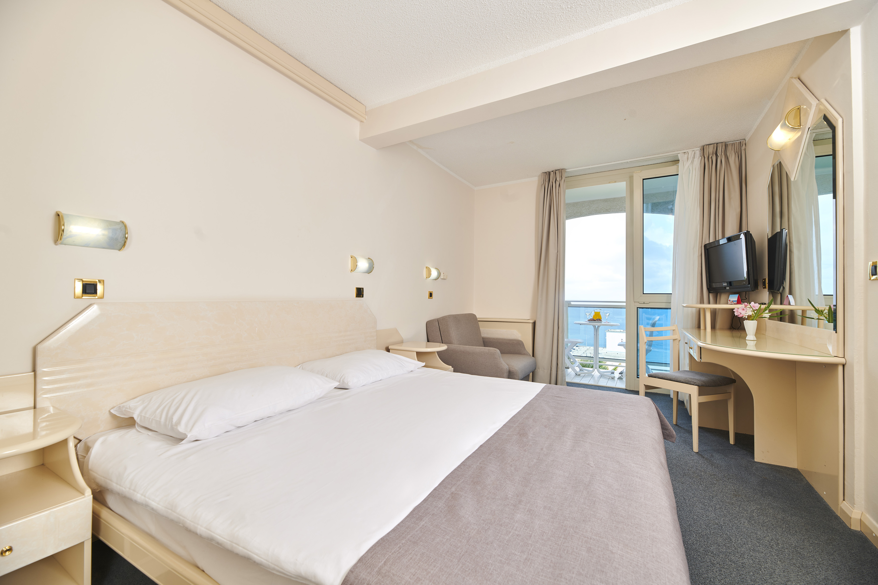 a room with a bed and a television