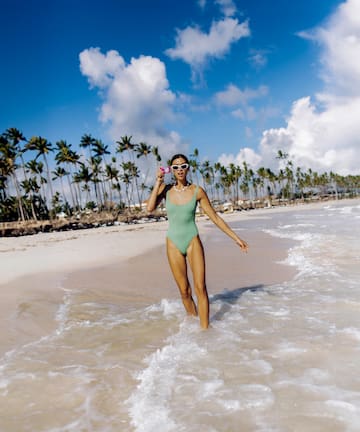 a woman in a swimsuit on a beach