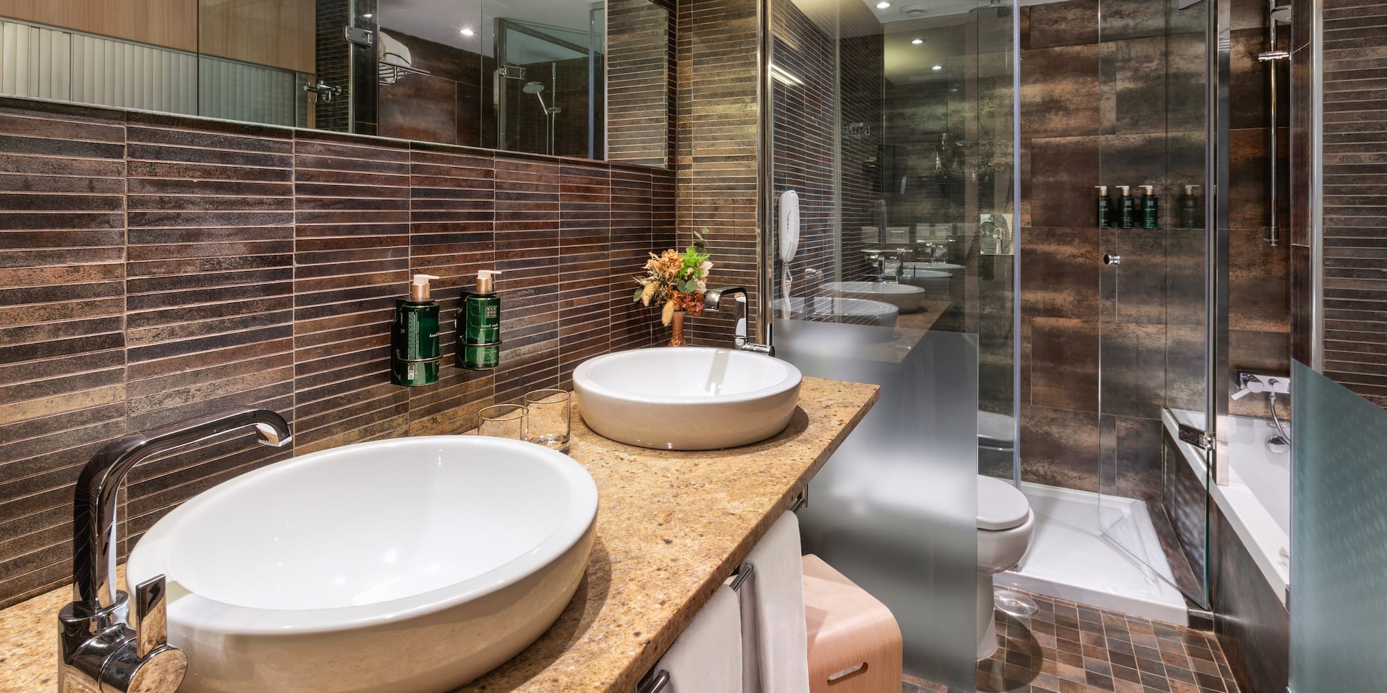 a bathroom with two sinks and a shower