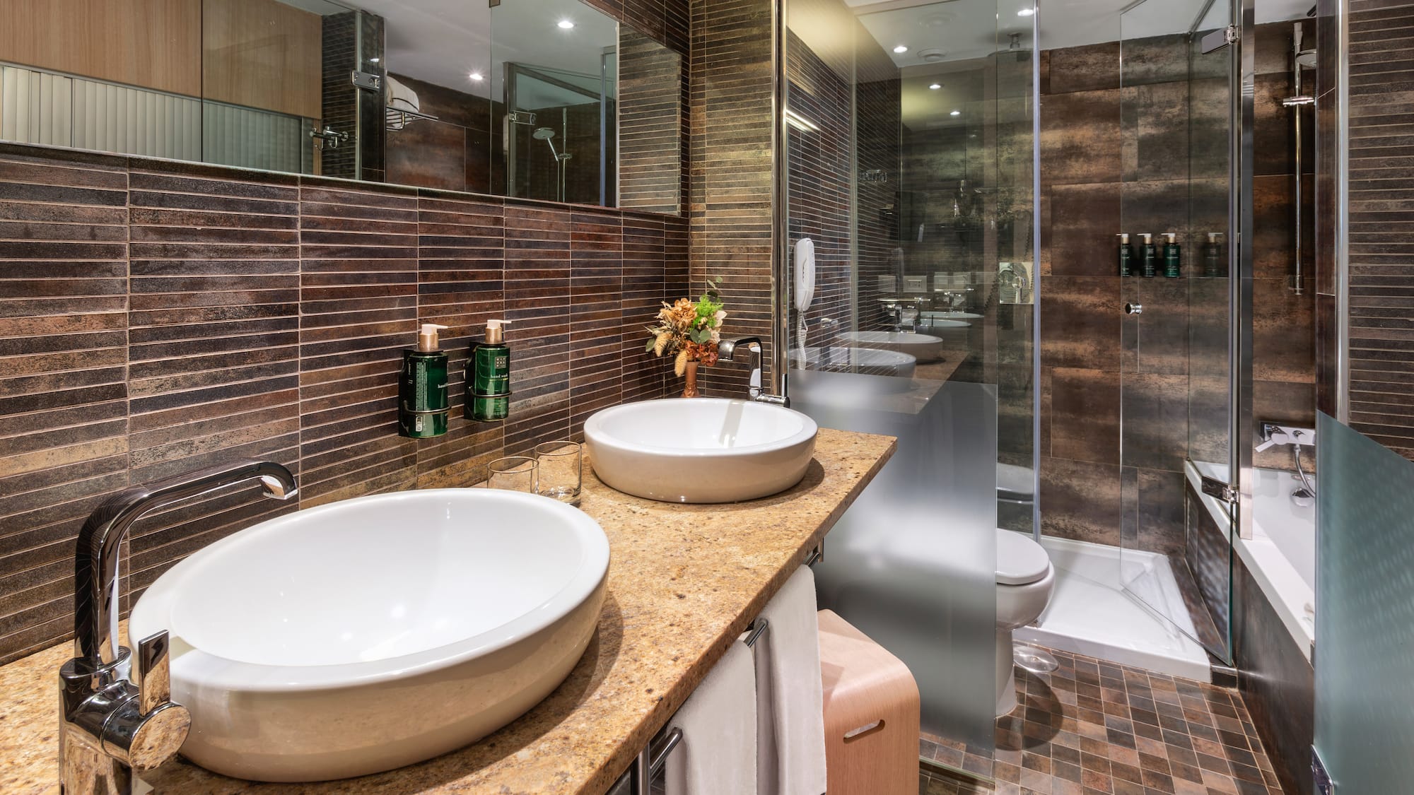 a bathroom with two sinks and a shower