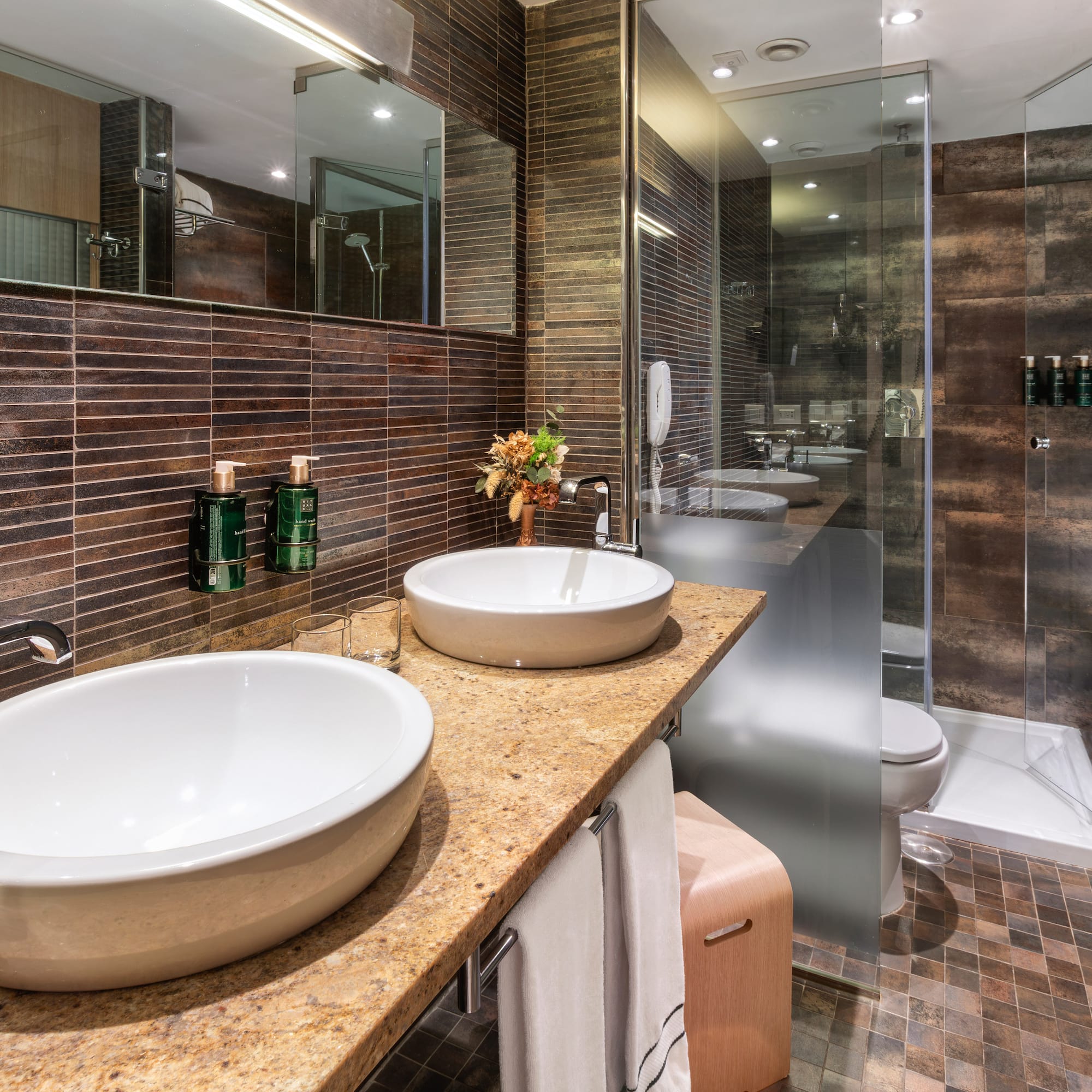 a bathroom with two sinks and a shower