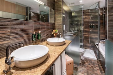 a bathroom with two sinks and a shower