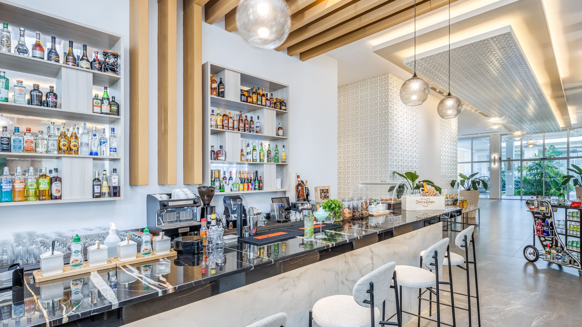 a bar with stools and bottles