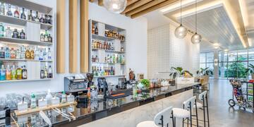 a bar with stools and bottles