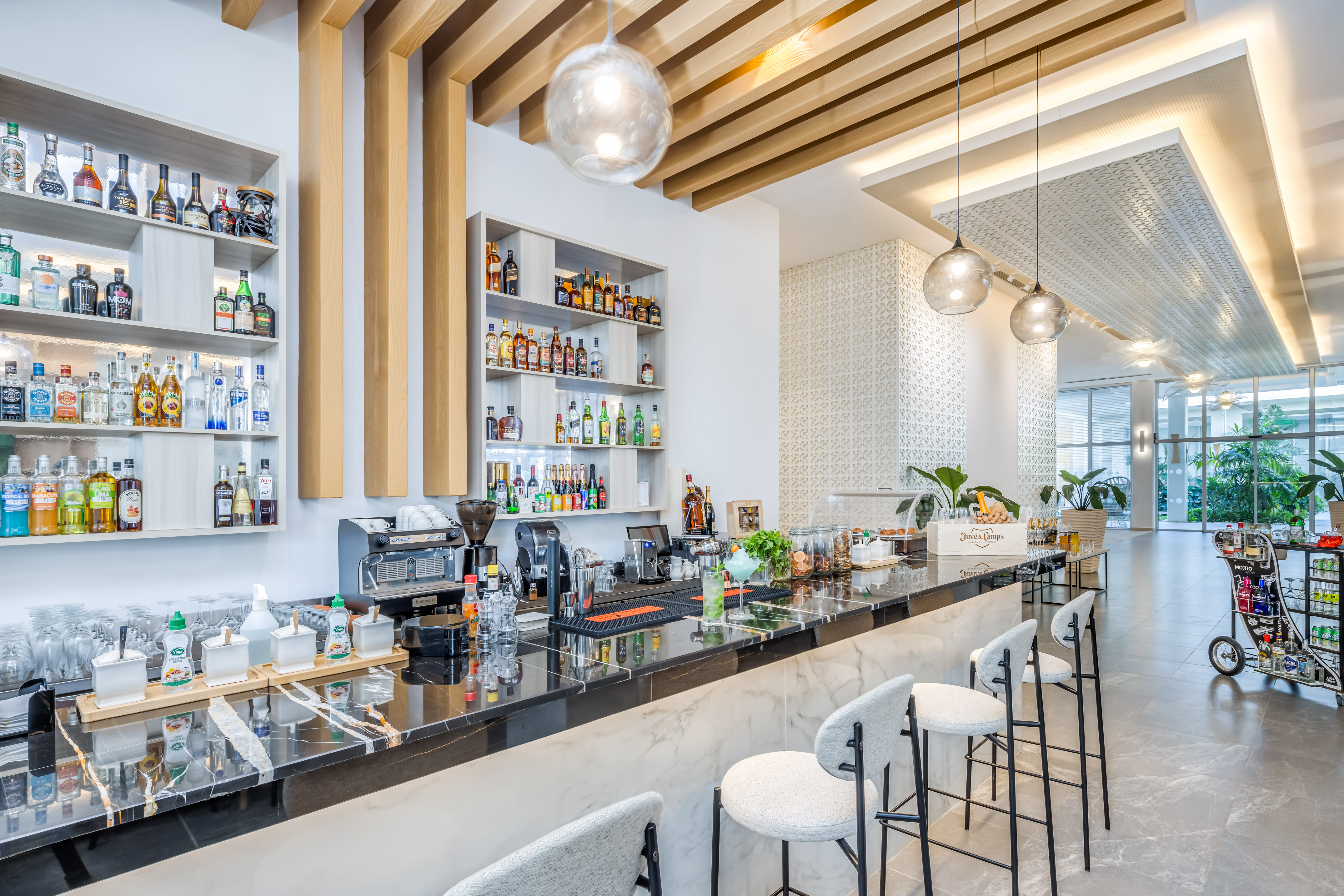 a bar with stools and bottles