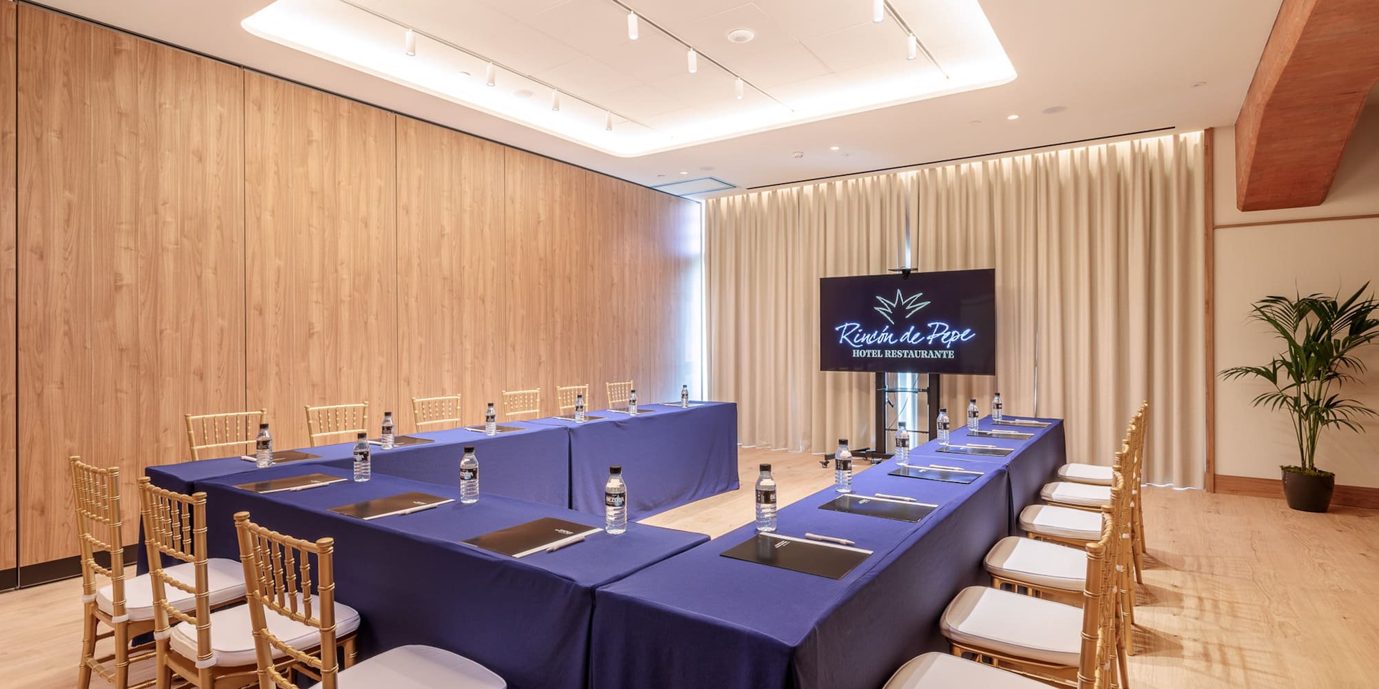 a room with a long table and chairs