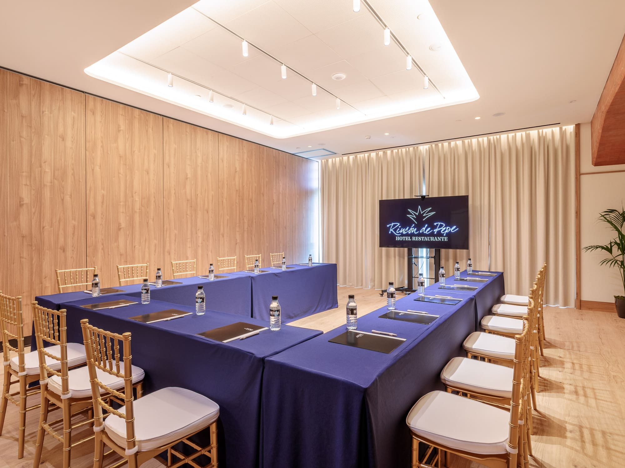 a room with a long table and chairs