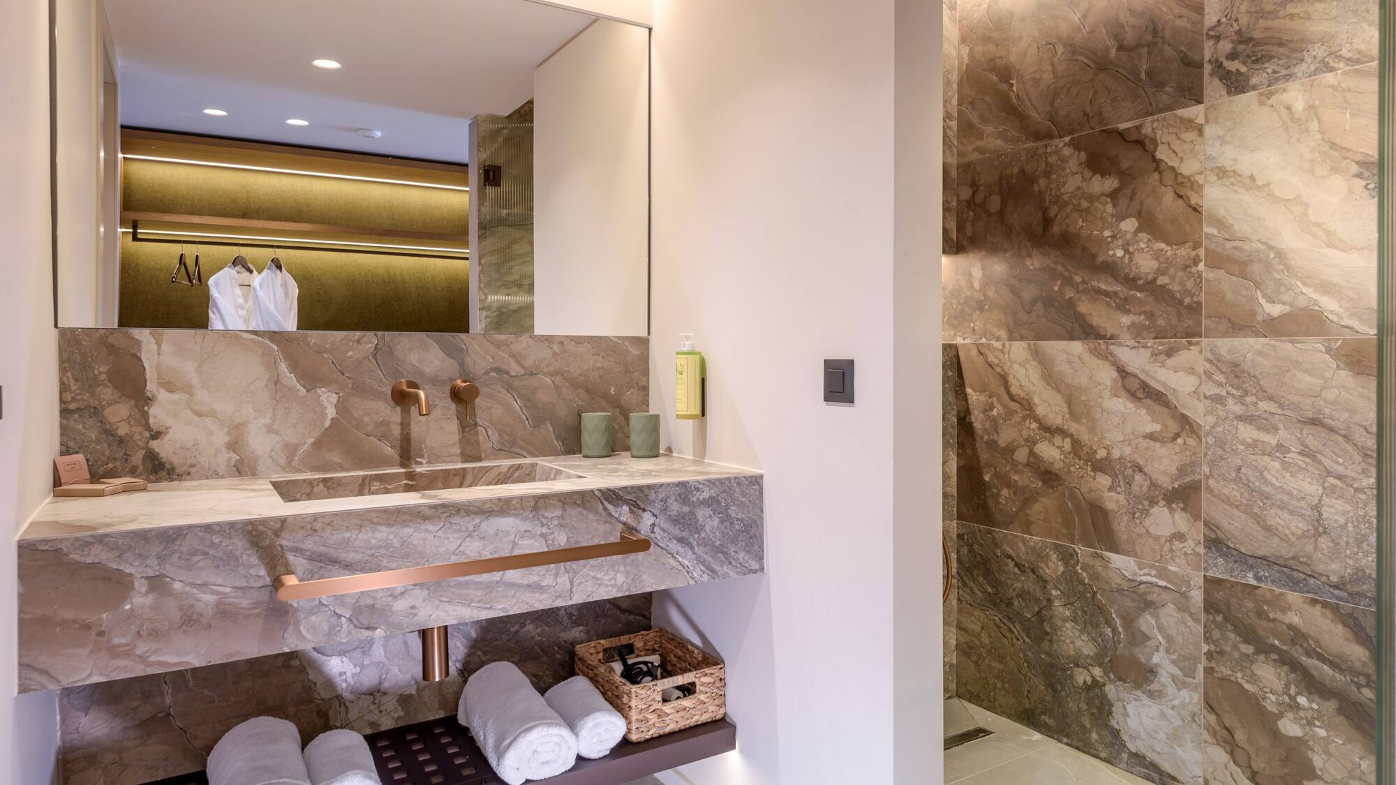 a bathroom with marble walls and a sink.
