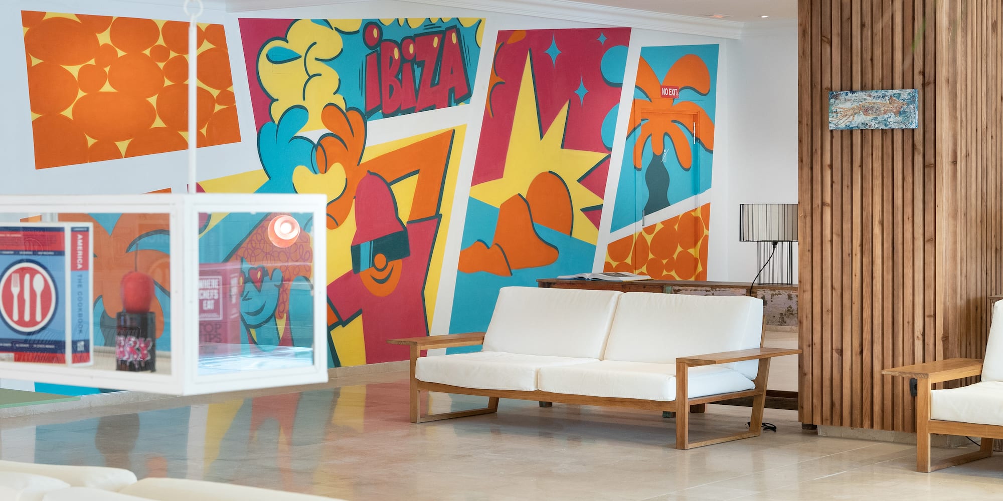 a room with a couch and colorful wall