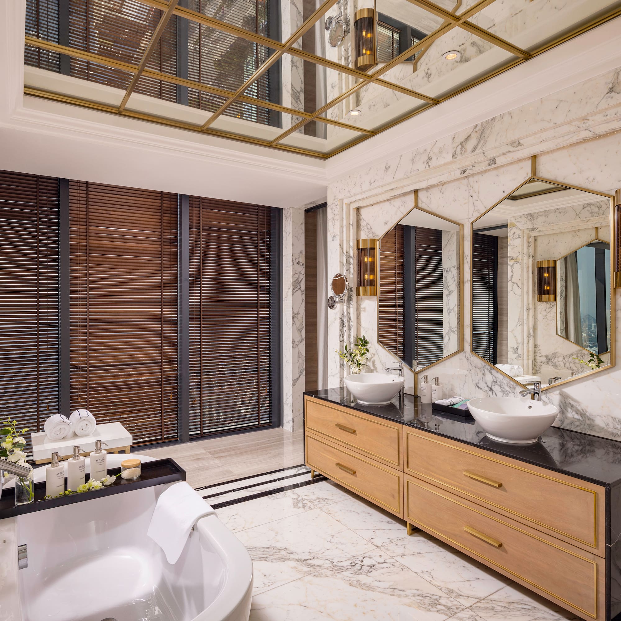 a bathroom with a large mirror and a tub