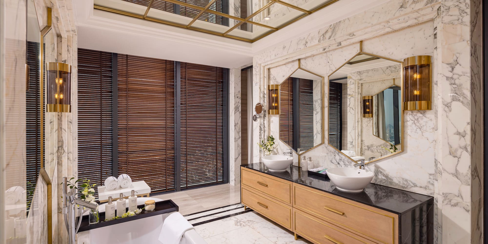 a bathroom with a large mirror and a tub