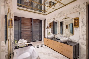 a bathroom with a large mirror and a tub