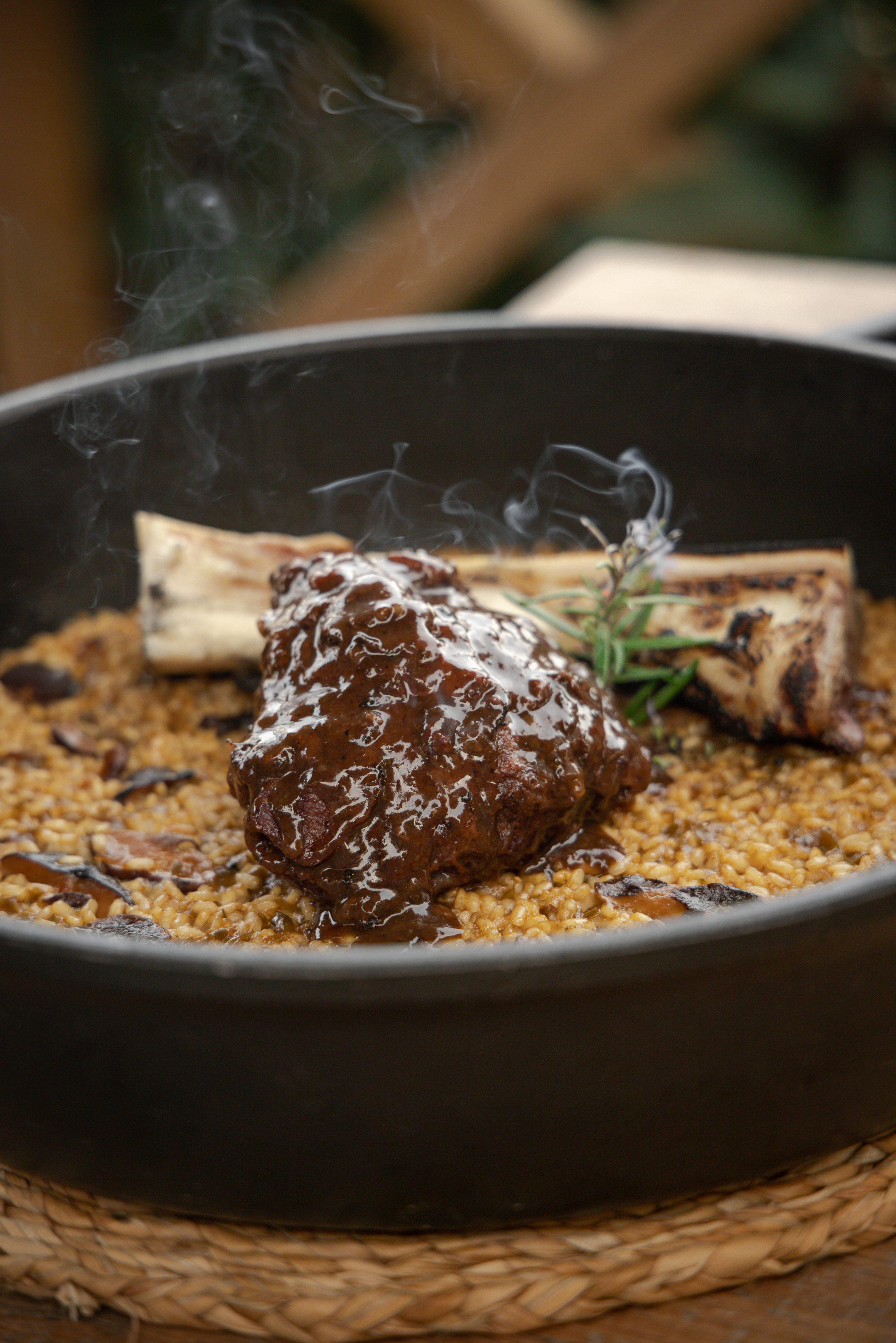 Steaming braised short rib with mushroom risotto, bone marrow, and rosemary.
