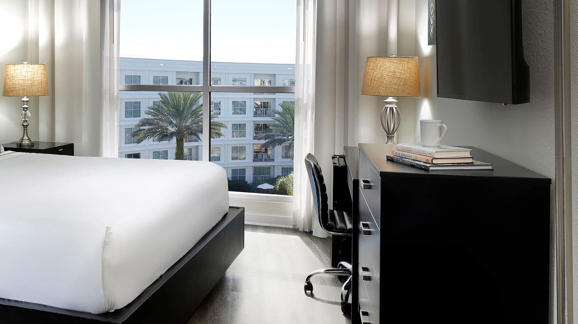 a room with a bed and a tv