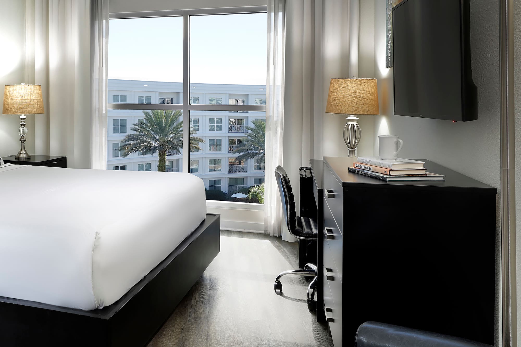 a room with a bed and a tv