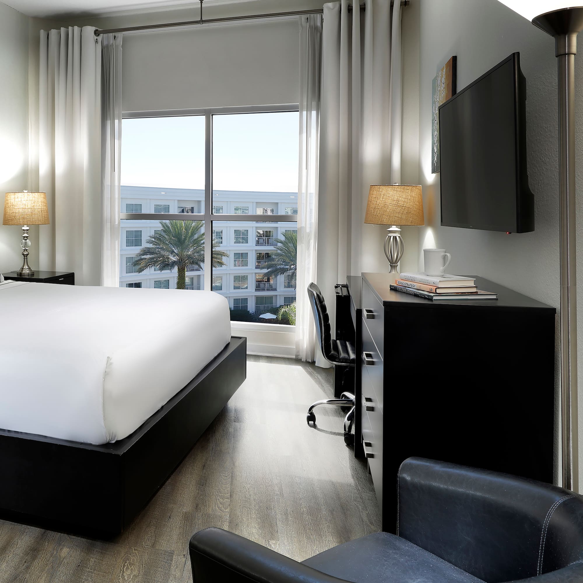 a room with a bed and a tv