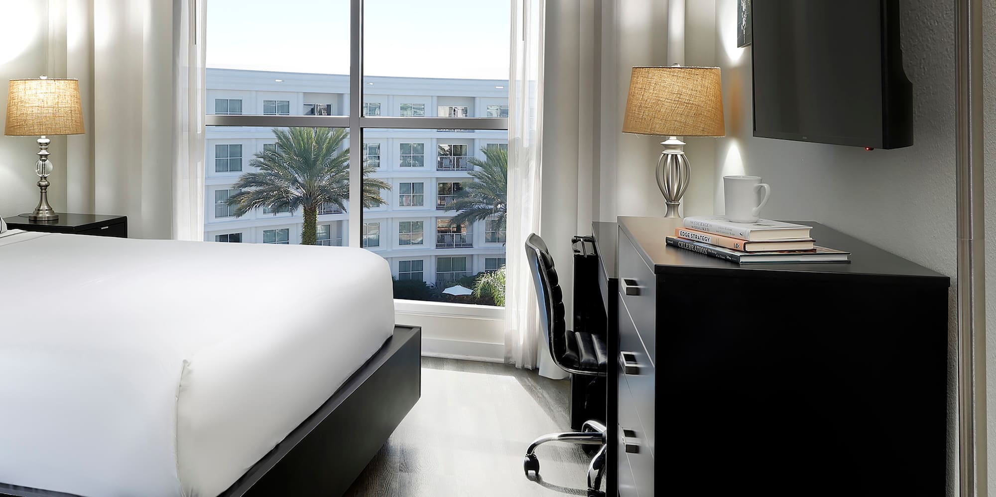 a room with a bed and a tv