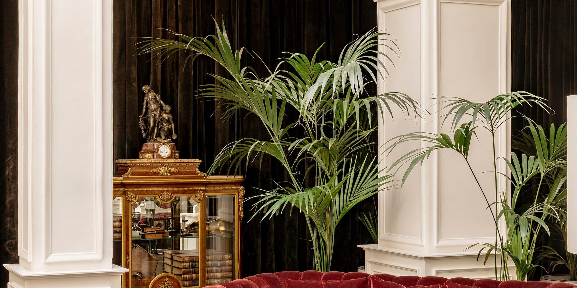 a room with a red couch and chairs
