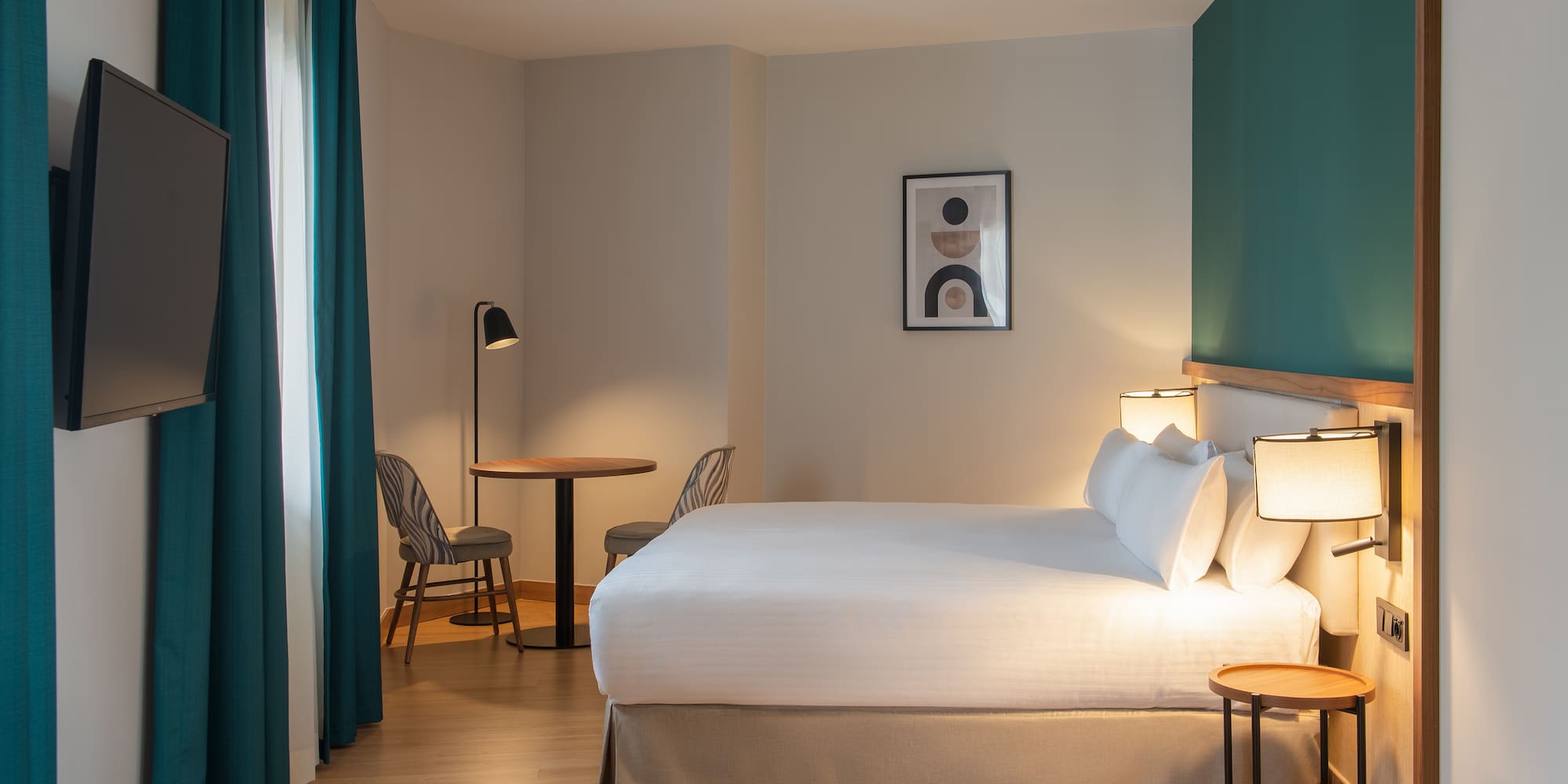 a room with a bed and table and chairs