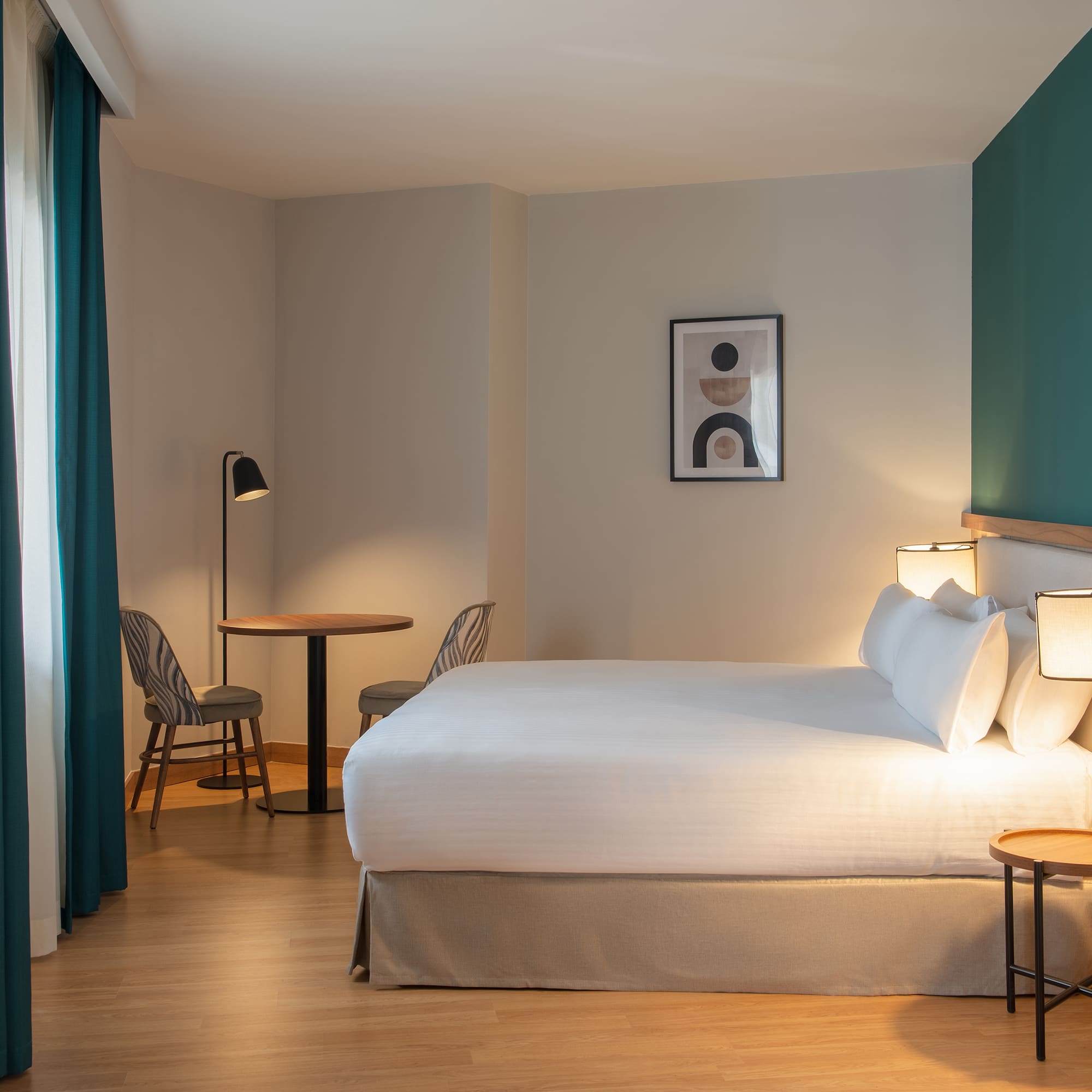 a room with a bed and table and chairs