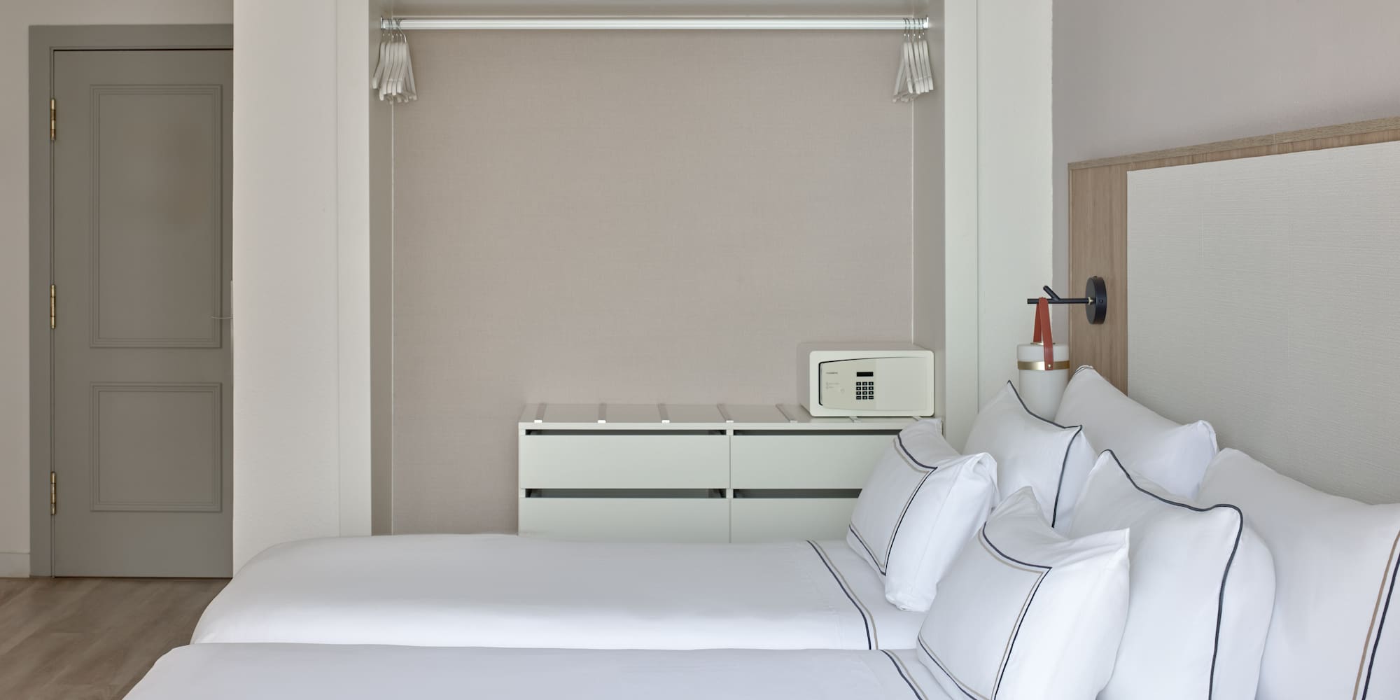 a room with two beds and a mirror