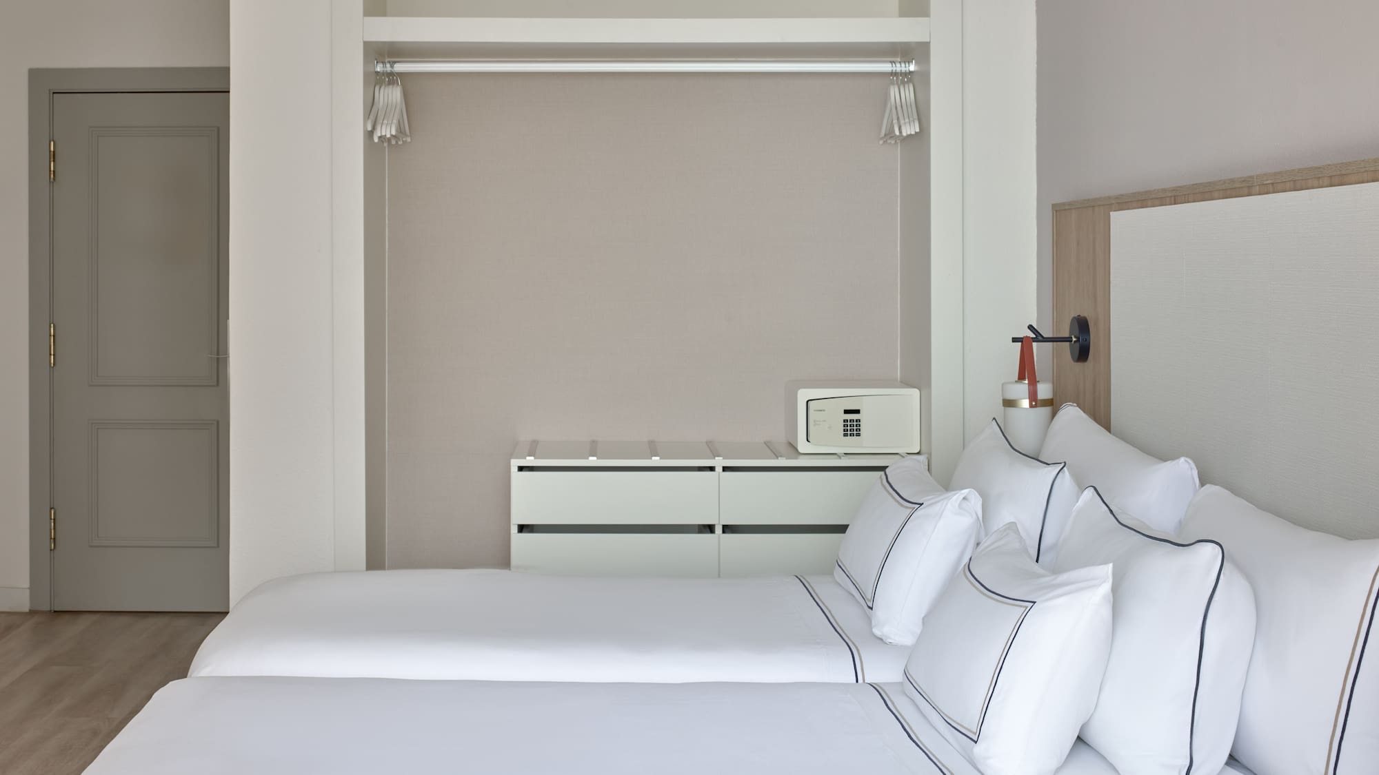 a room with two beds and a mirror