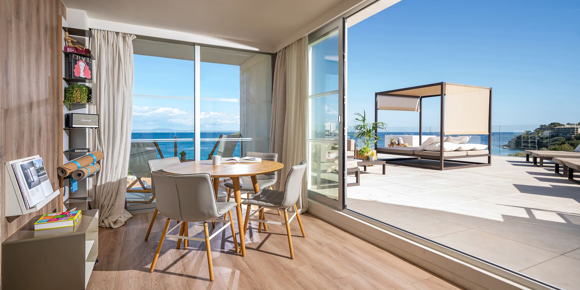 a room with a table and chairs and a large glass door