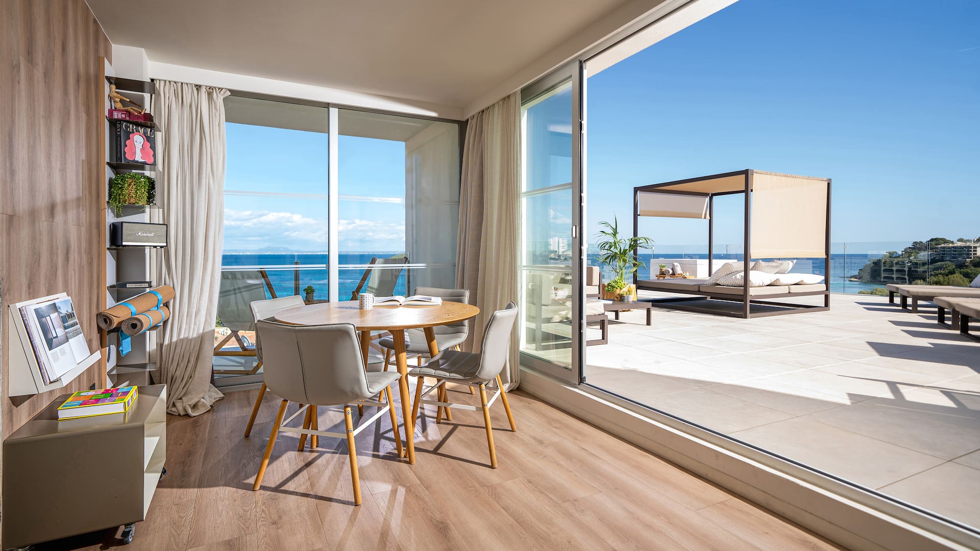 a room with a table and chairs and a large glass door