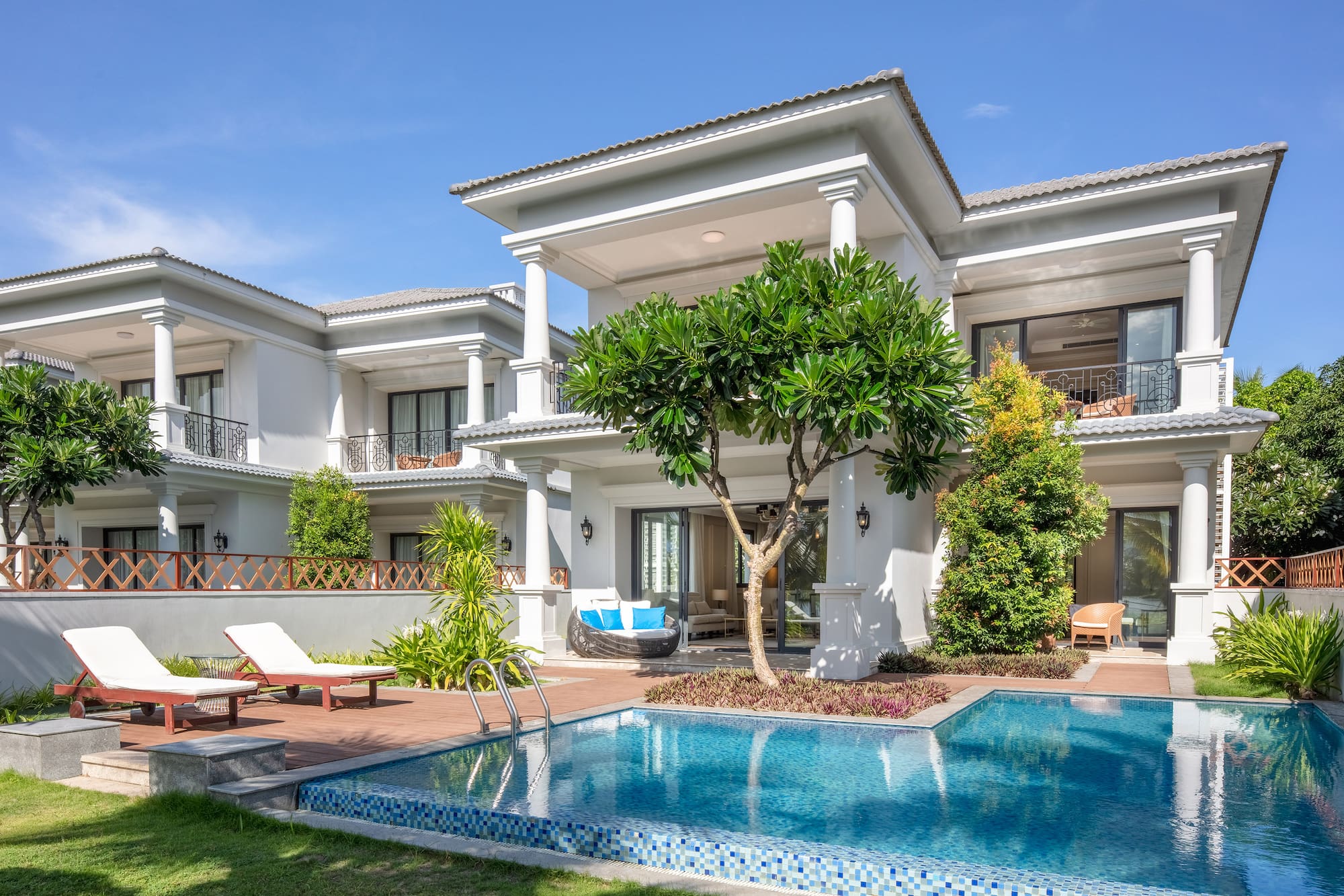 Luxury white villa with private pool, modern architecture, and tropical garden.