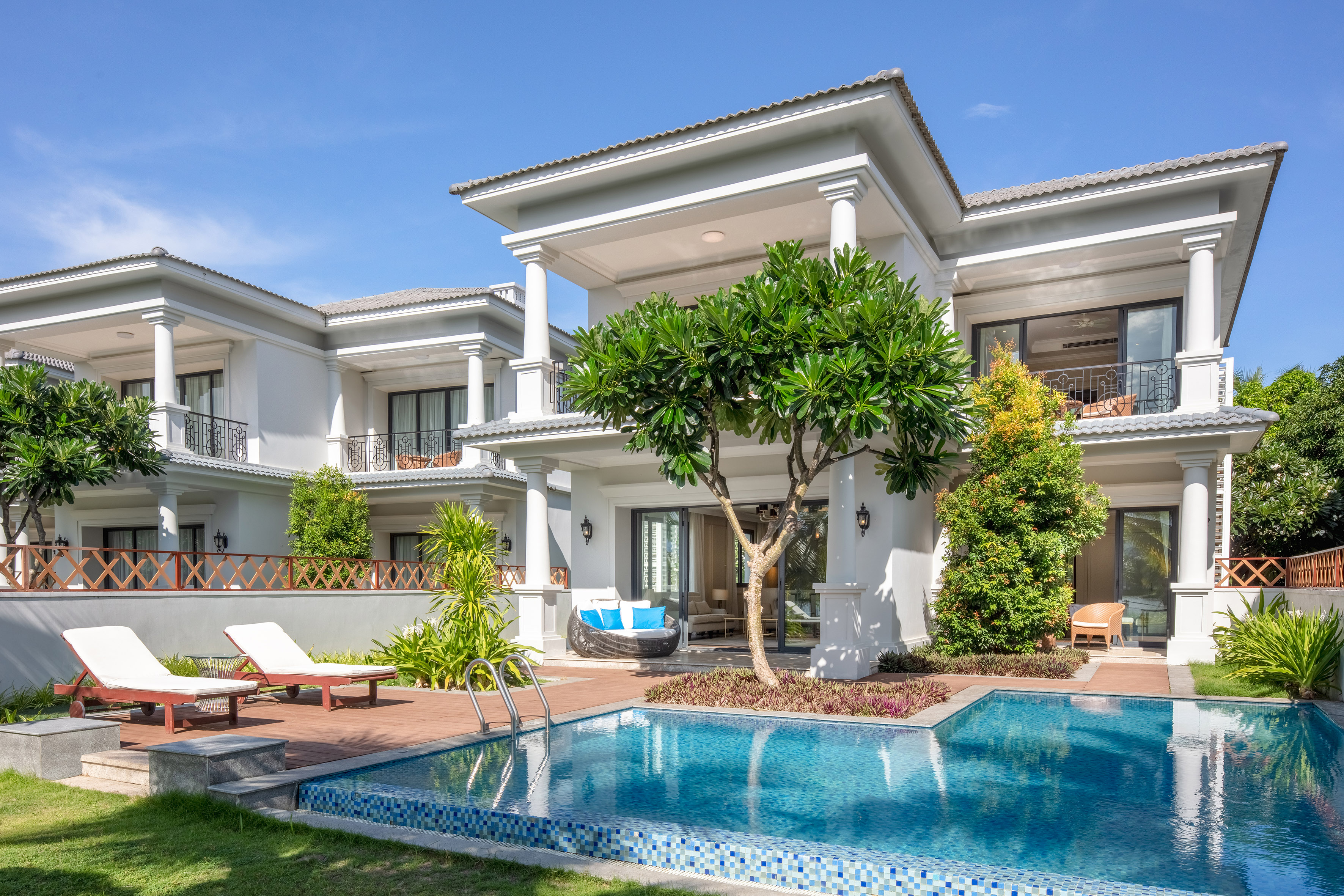 Luxury white villa with private pool, modern architecture, and tropical garden.