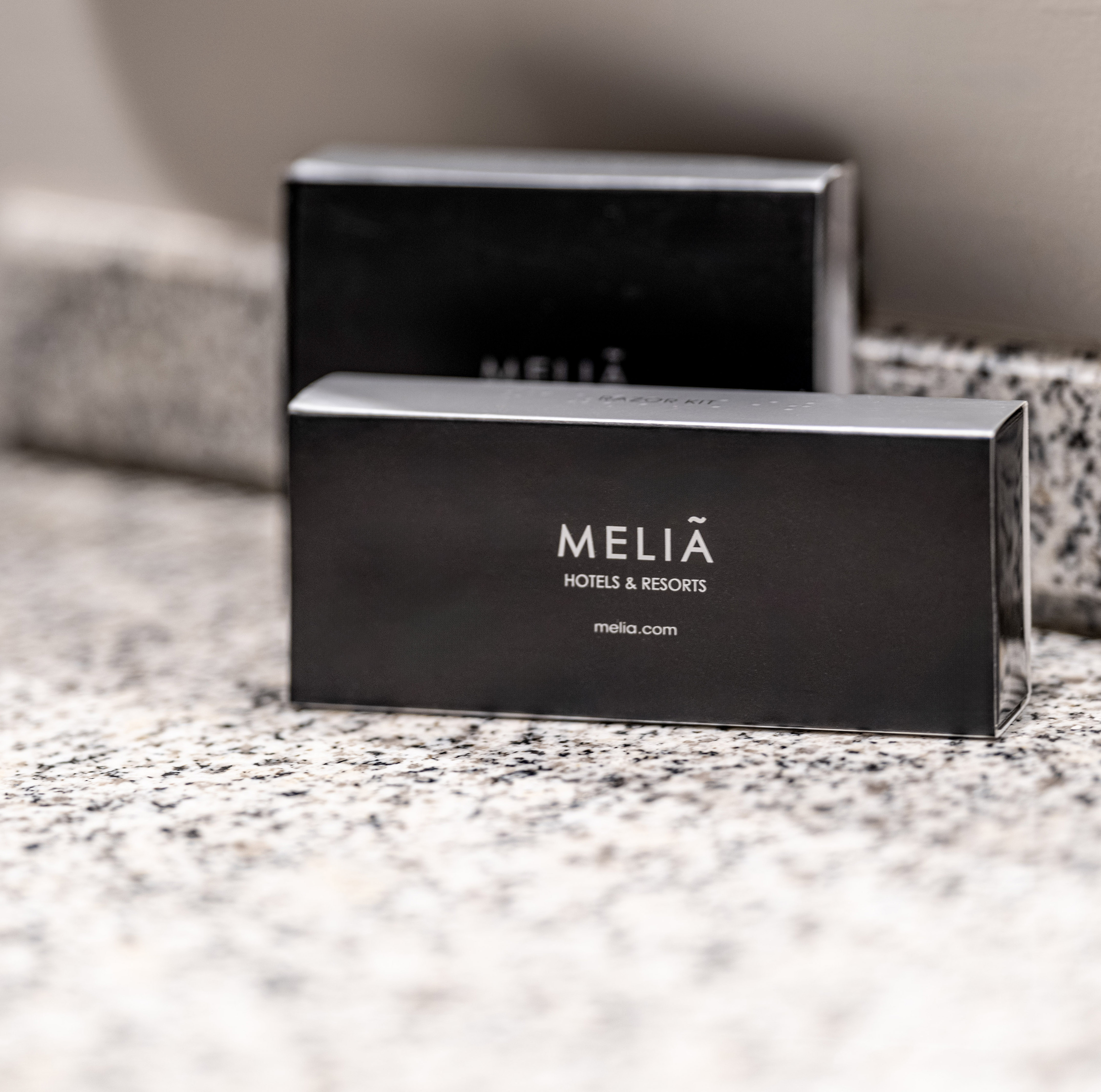 Black Melia Hotels & Resorts razor kit amenity on granite.