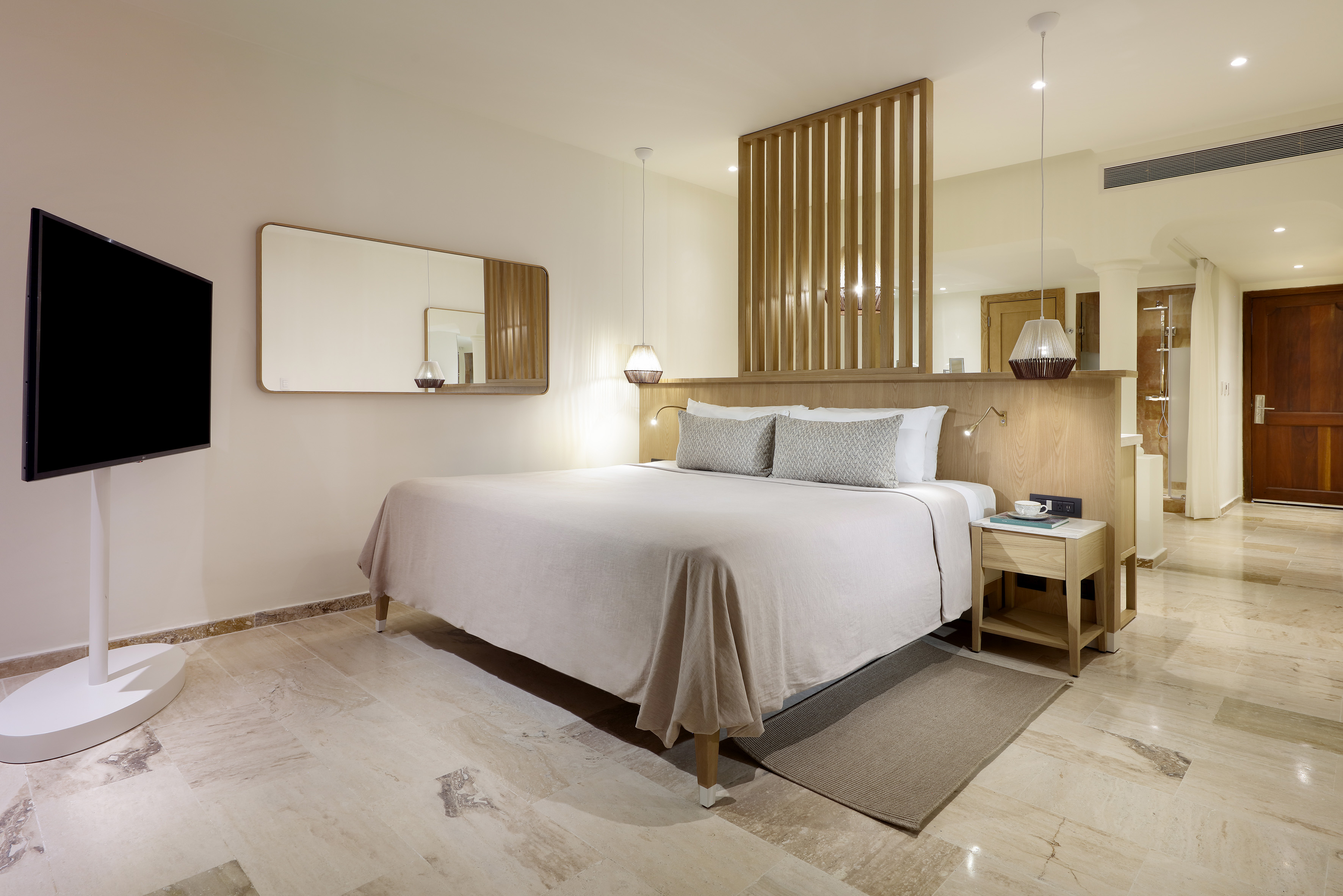 a bed with a mirror above it