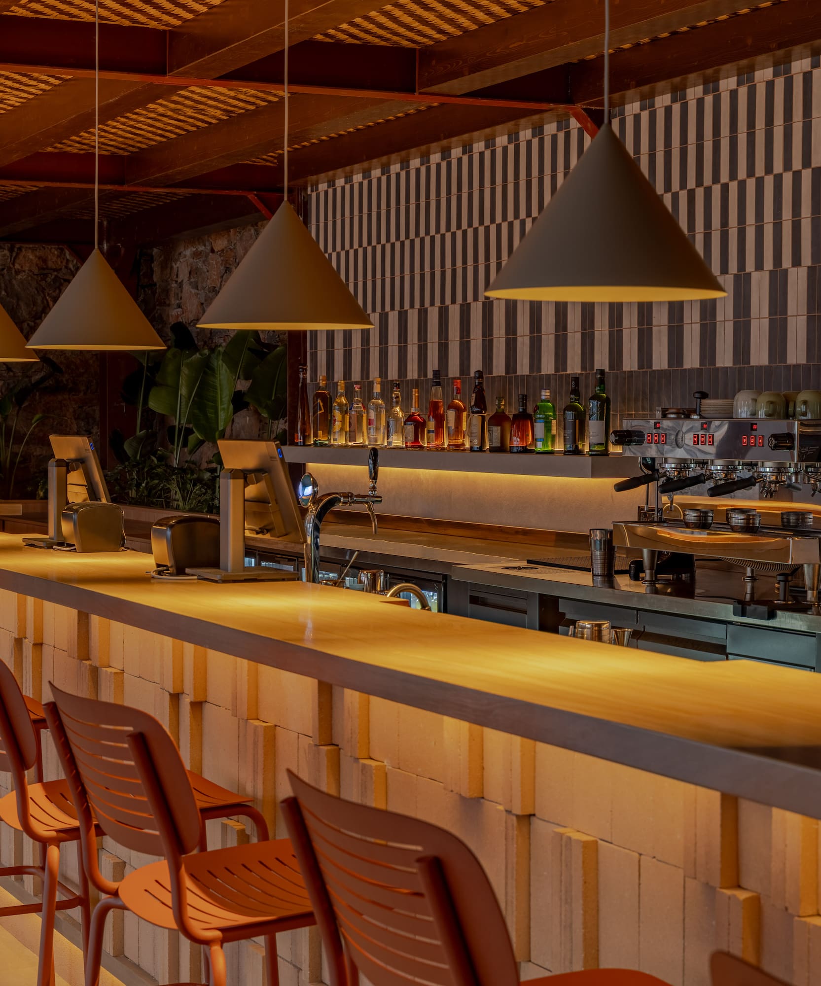 a bar with chairs and lights