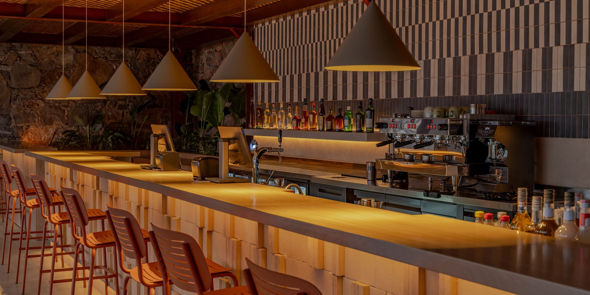 a bar with chairs and lights