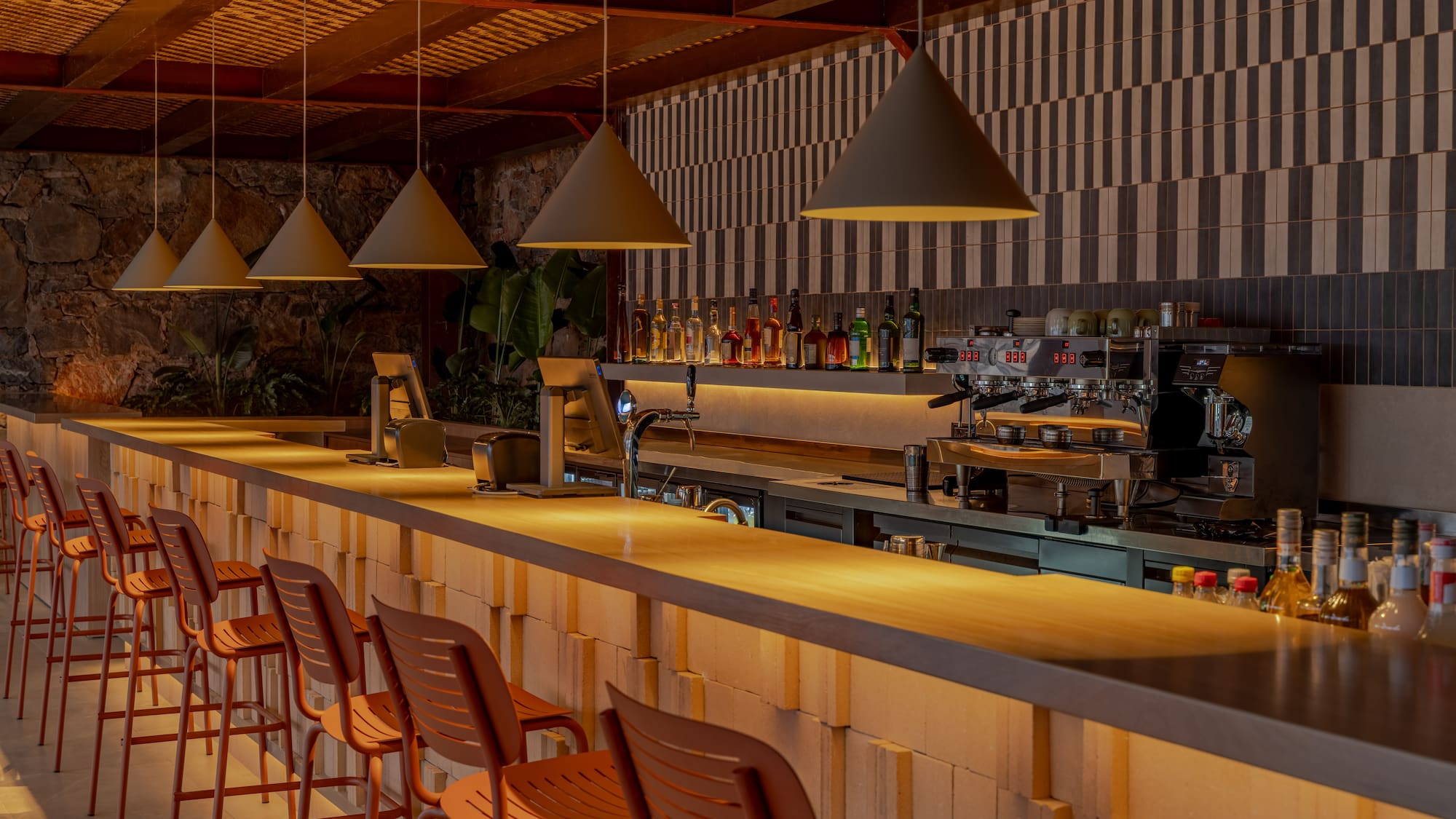 a bar with chairs and lights