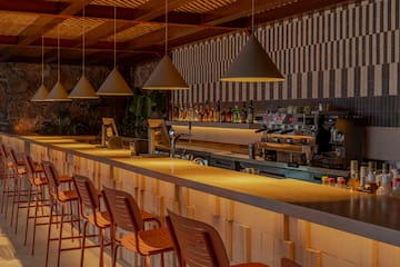 a bar with chairs and lights