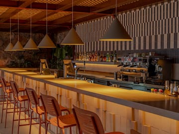 a bar with chairs and lights