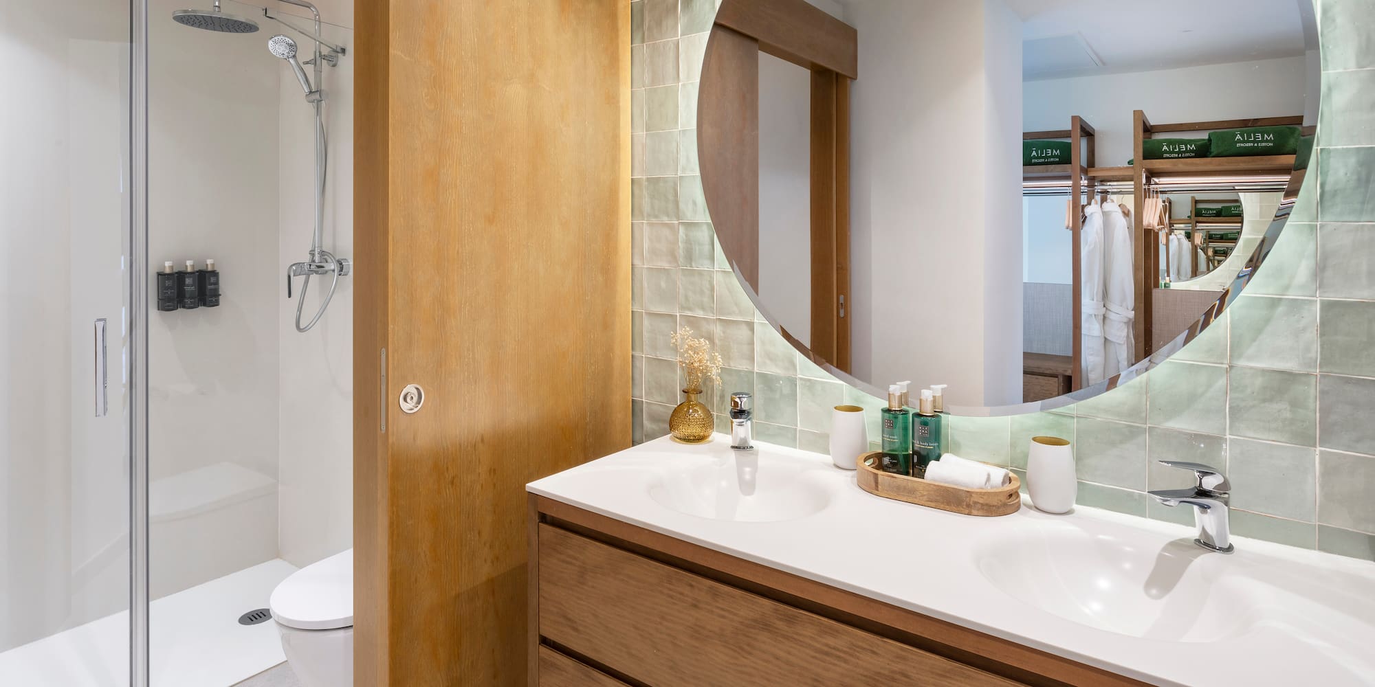a bathroom with a round mirror