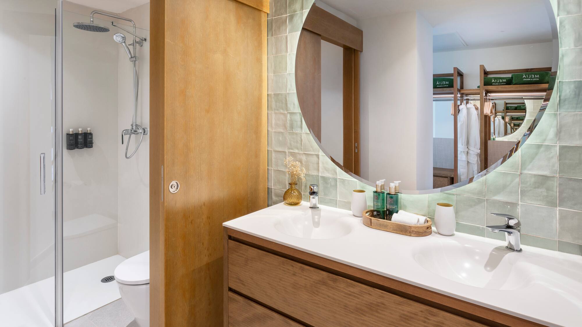 a bathroom with a round mirror