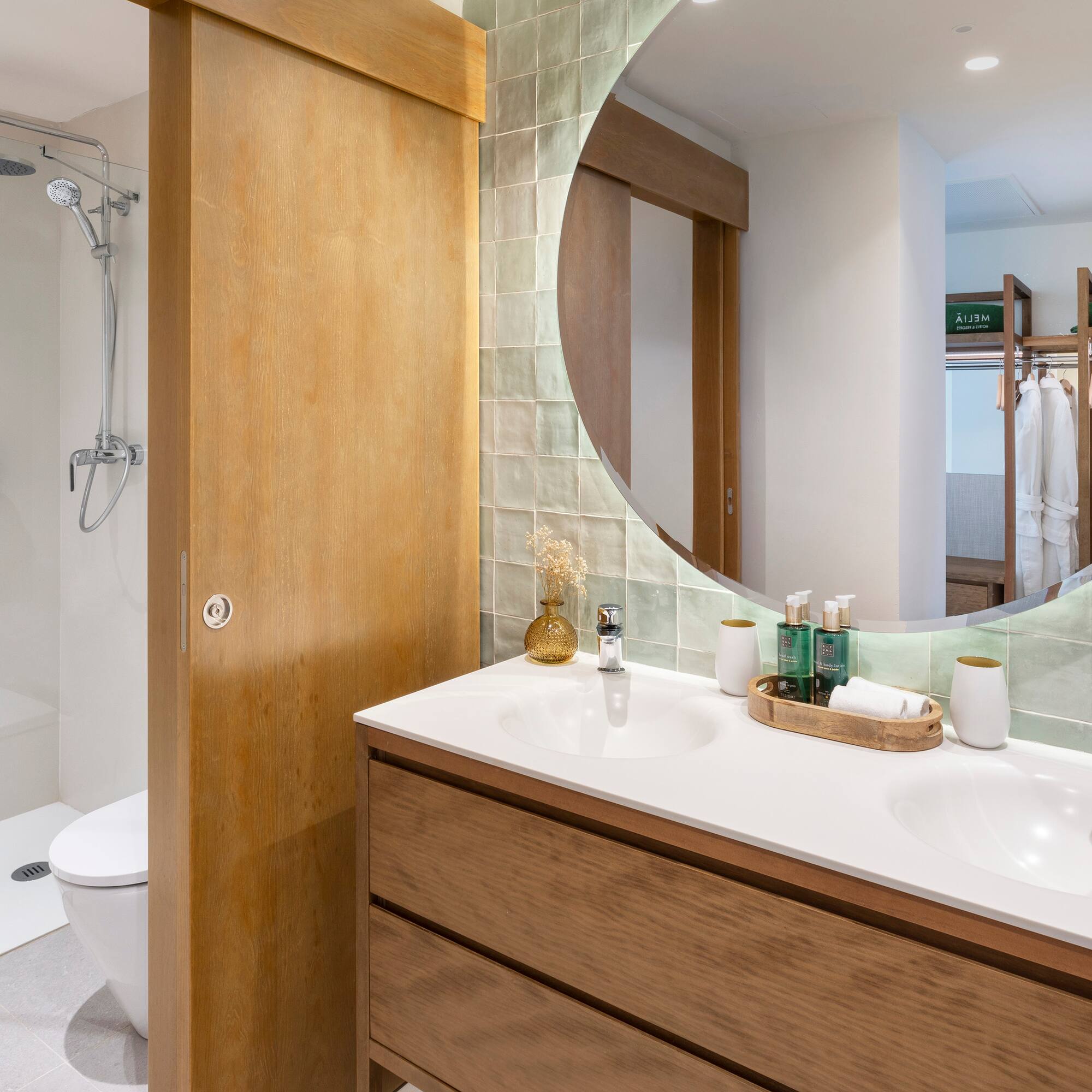 a bathroom with a round mirror