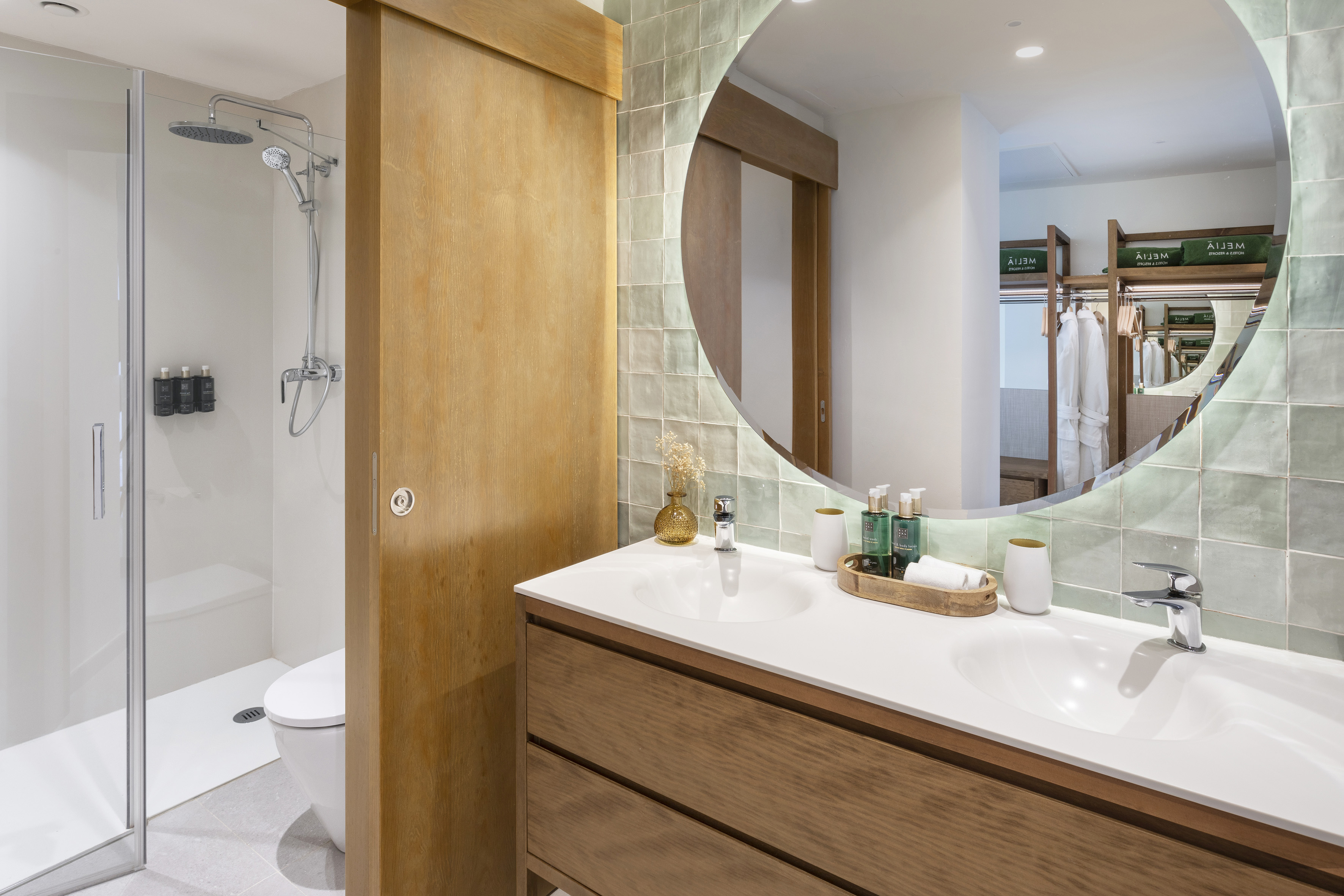 a bathroom with a round mirror