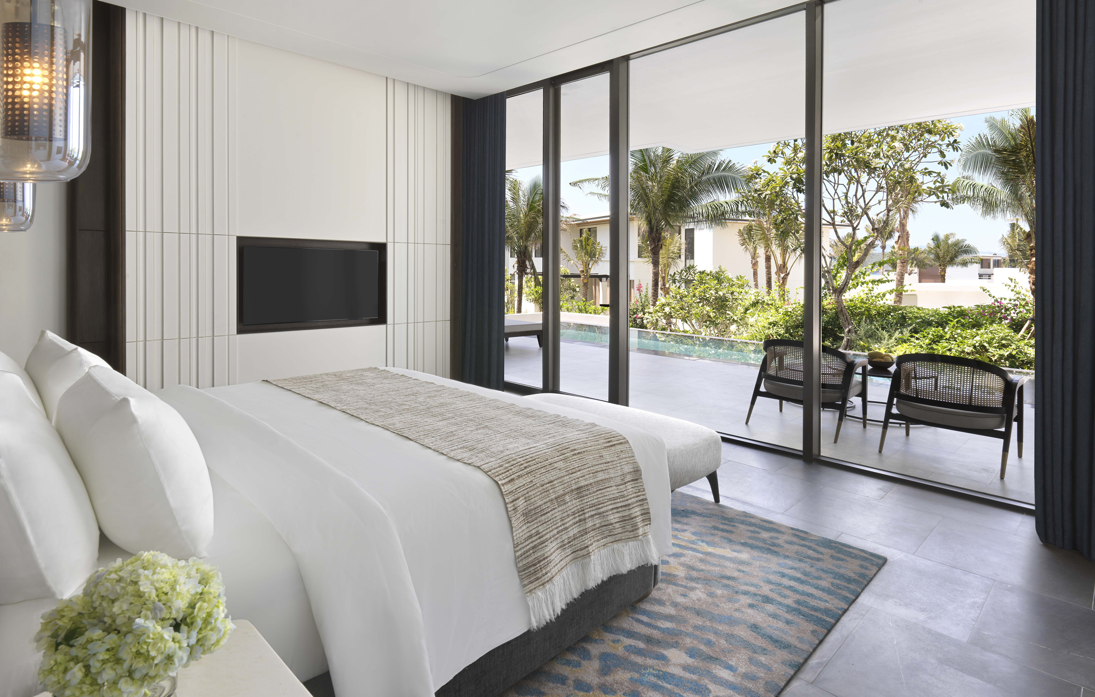 Sleek modern bedroom with private pool, palm trees, and outdoor patio.