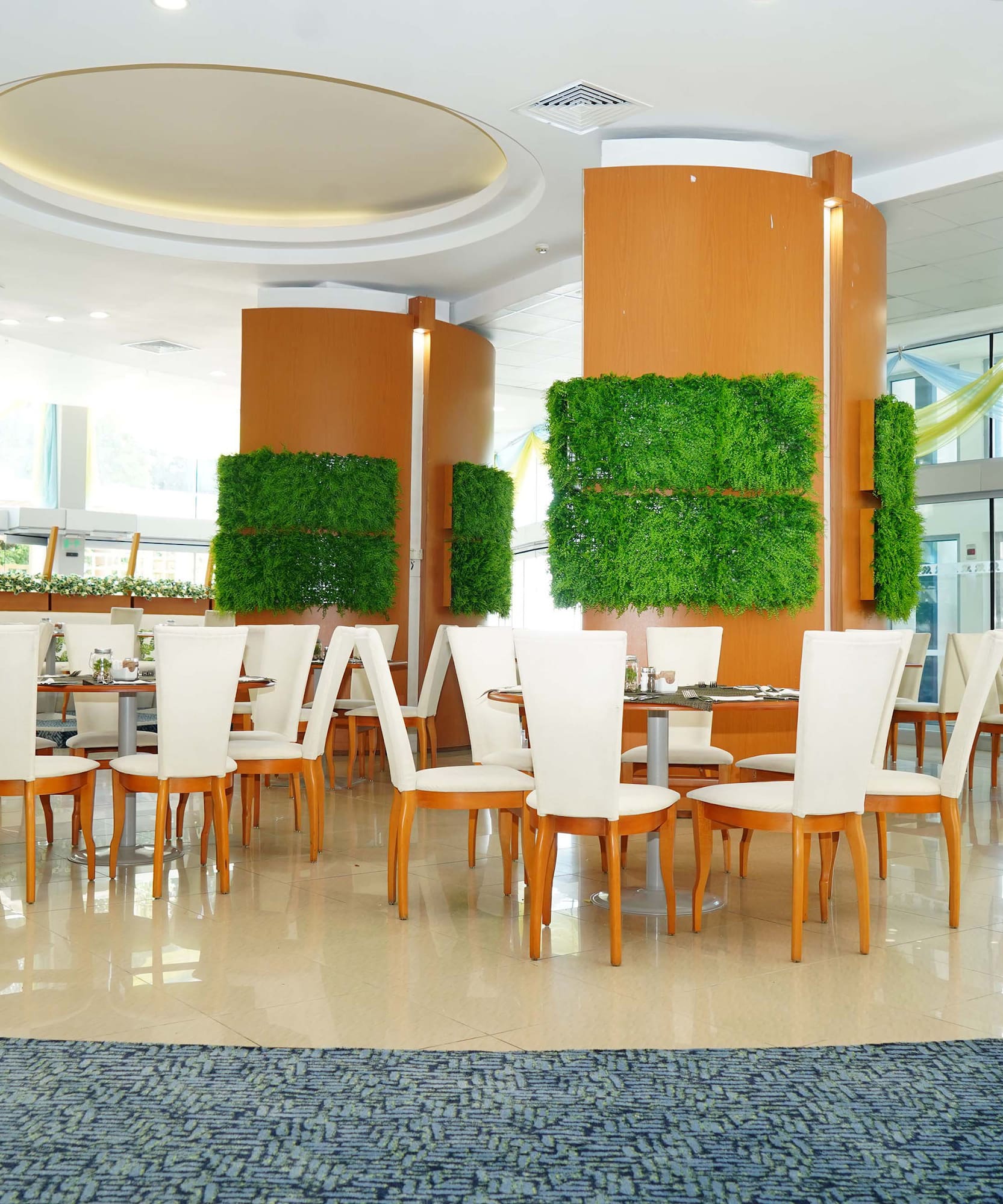 a room with white chairs and tables