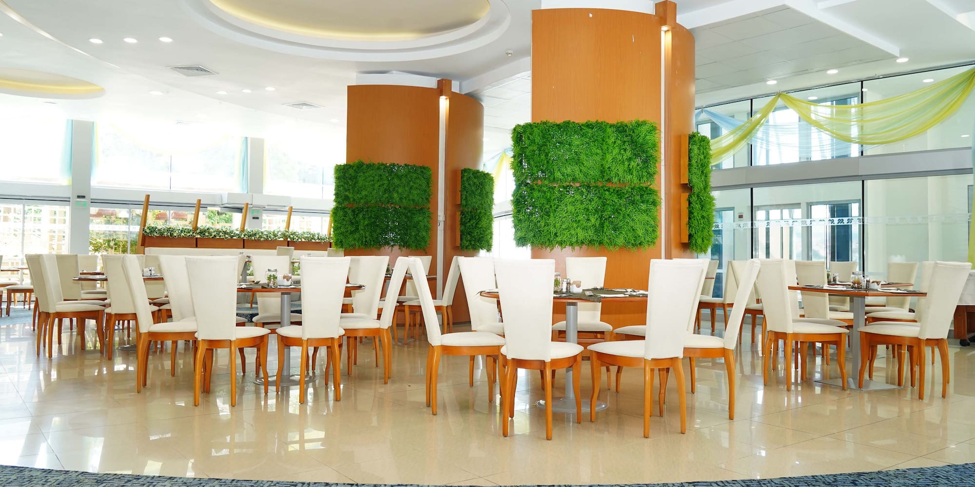 a room with white chairs and tables