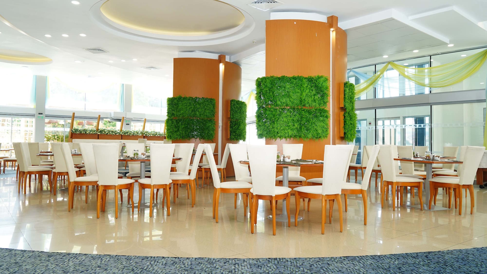 a room with white chairs and tables