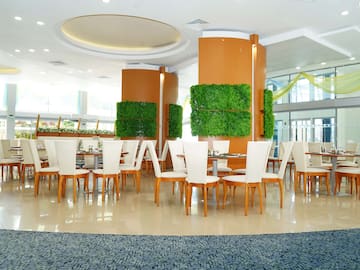 a room with white chairs and tables