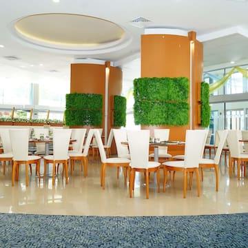 a room with white chairs and tables